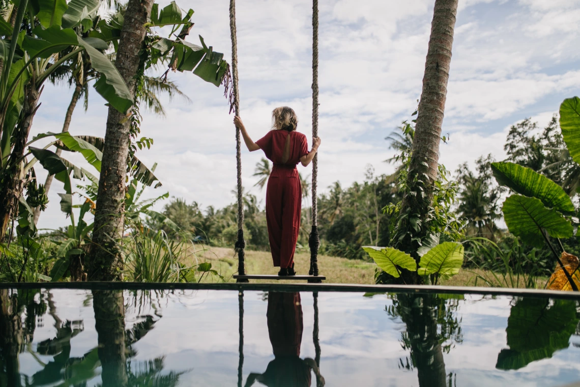 foto de la parte posterior de la mujer delgada con vestido largo mirando el cielo lluvioso disparo al aire libre de modelo femenino bien proporcionado disfrutando de vistas la naturaleza en el resort